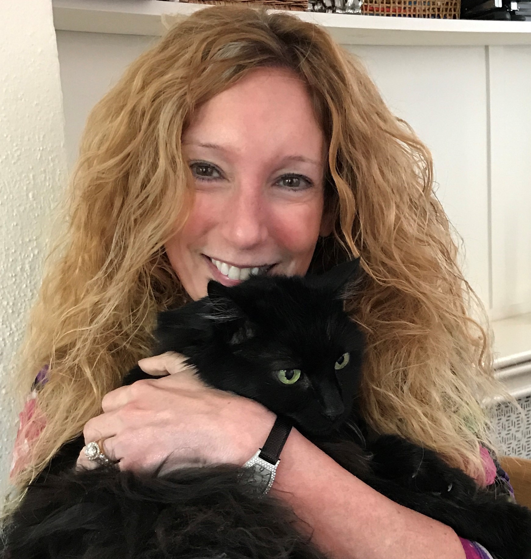 White woman holding black cat