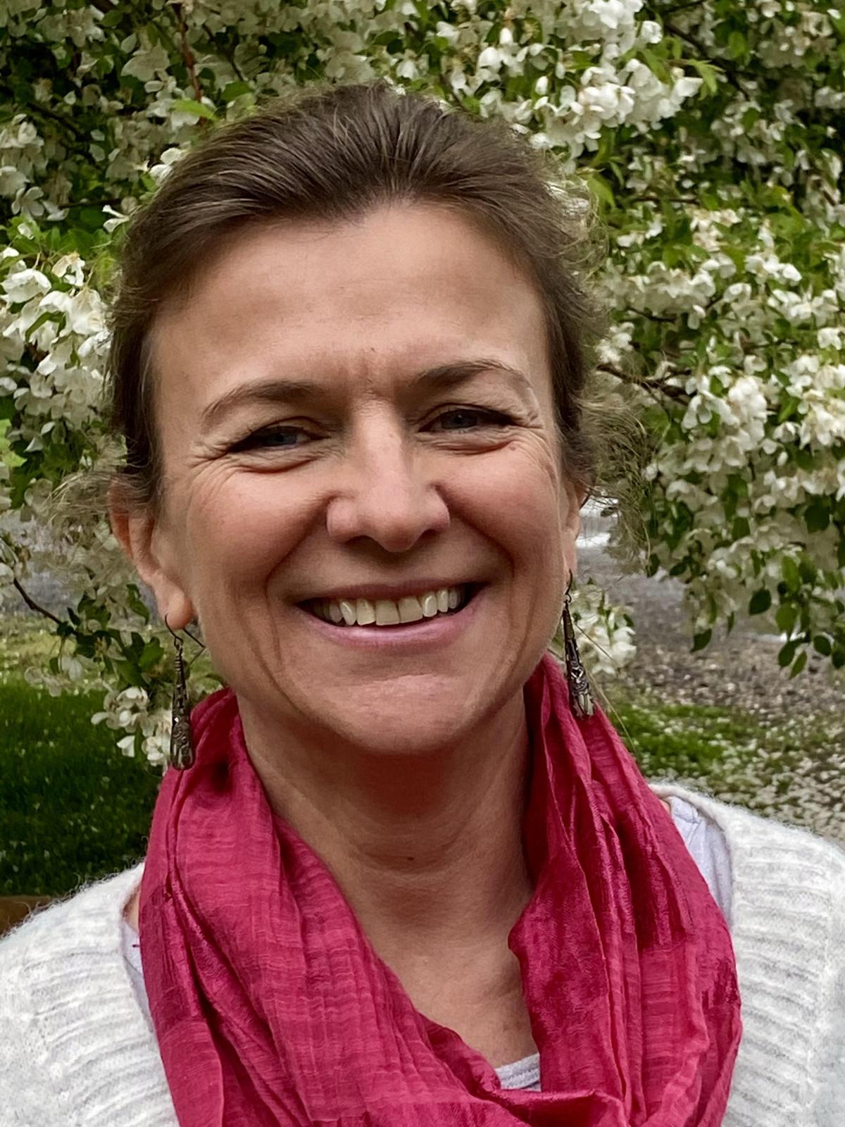 Smiling white woman with red scarf