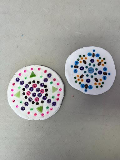 Mosaic tiles with clay, beads pressed into it